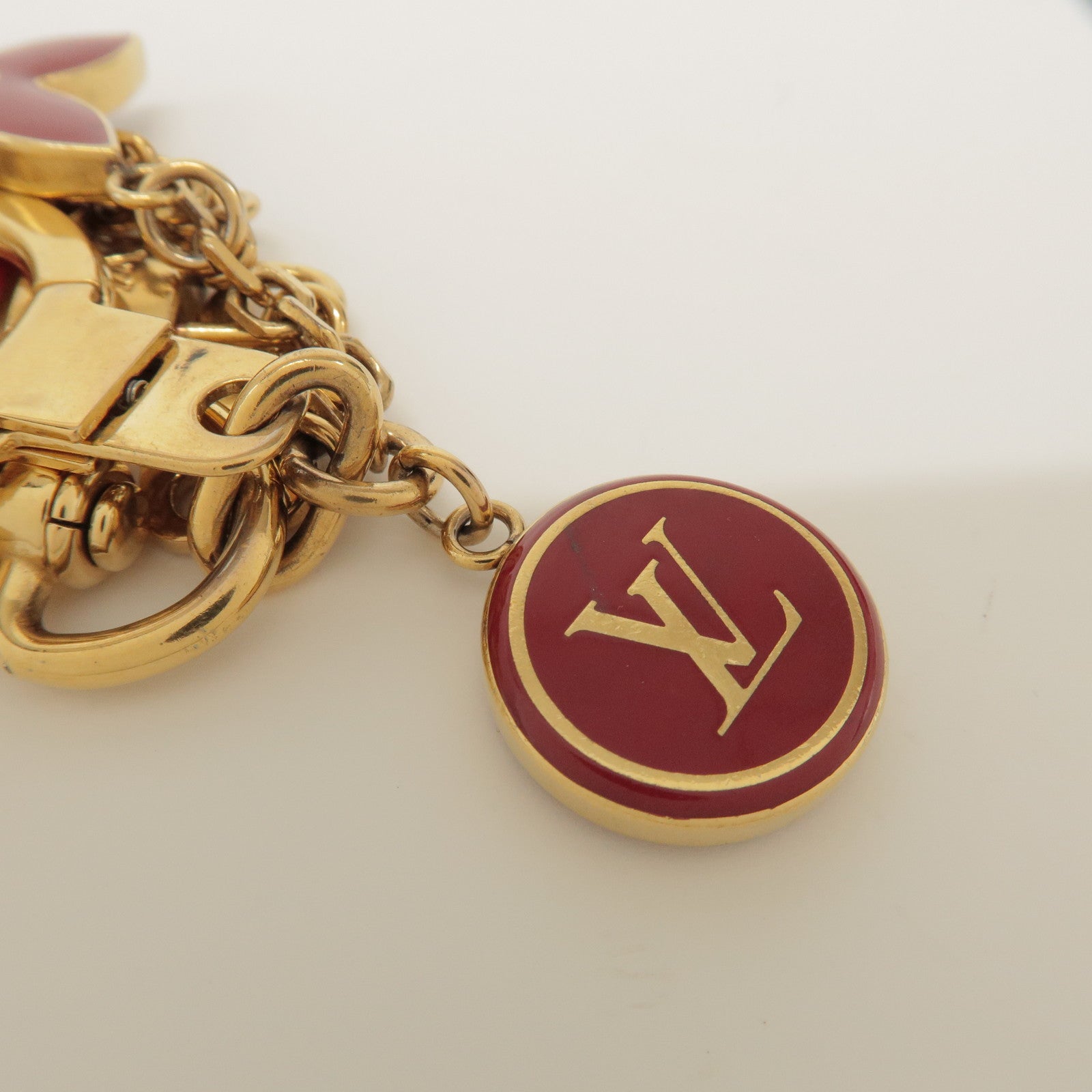 Louis Vuitton Porte Cles Pompille Metal Bag Charm Gold Red M91928