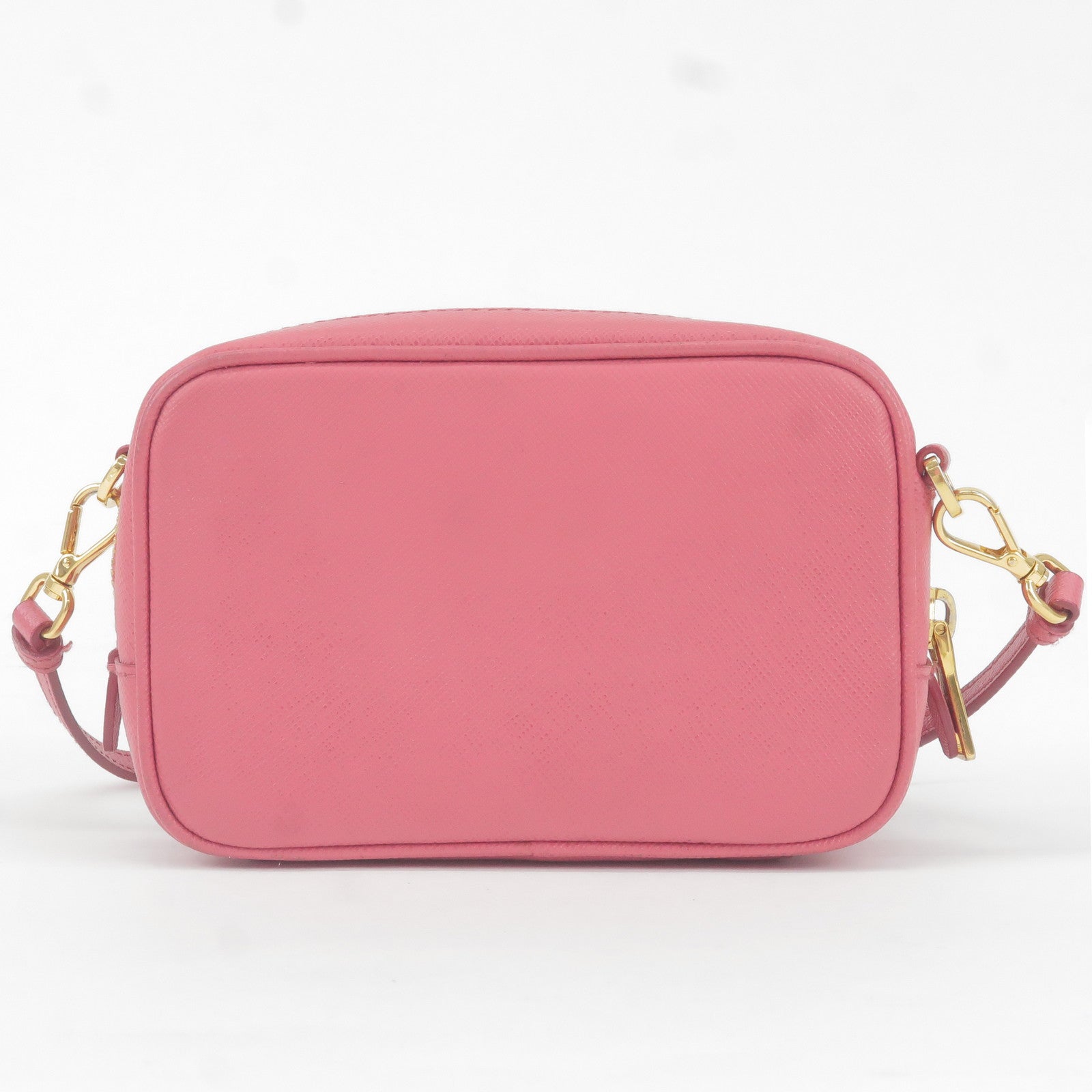 Dark and light pink bag, shoes and purse with a decorative bow in the shape  of