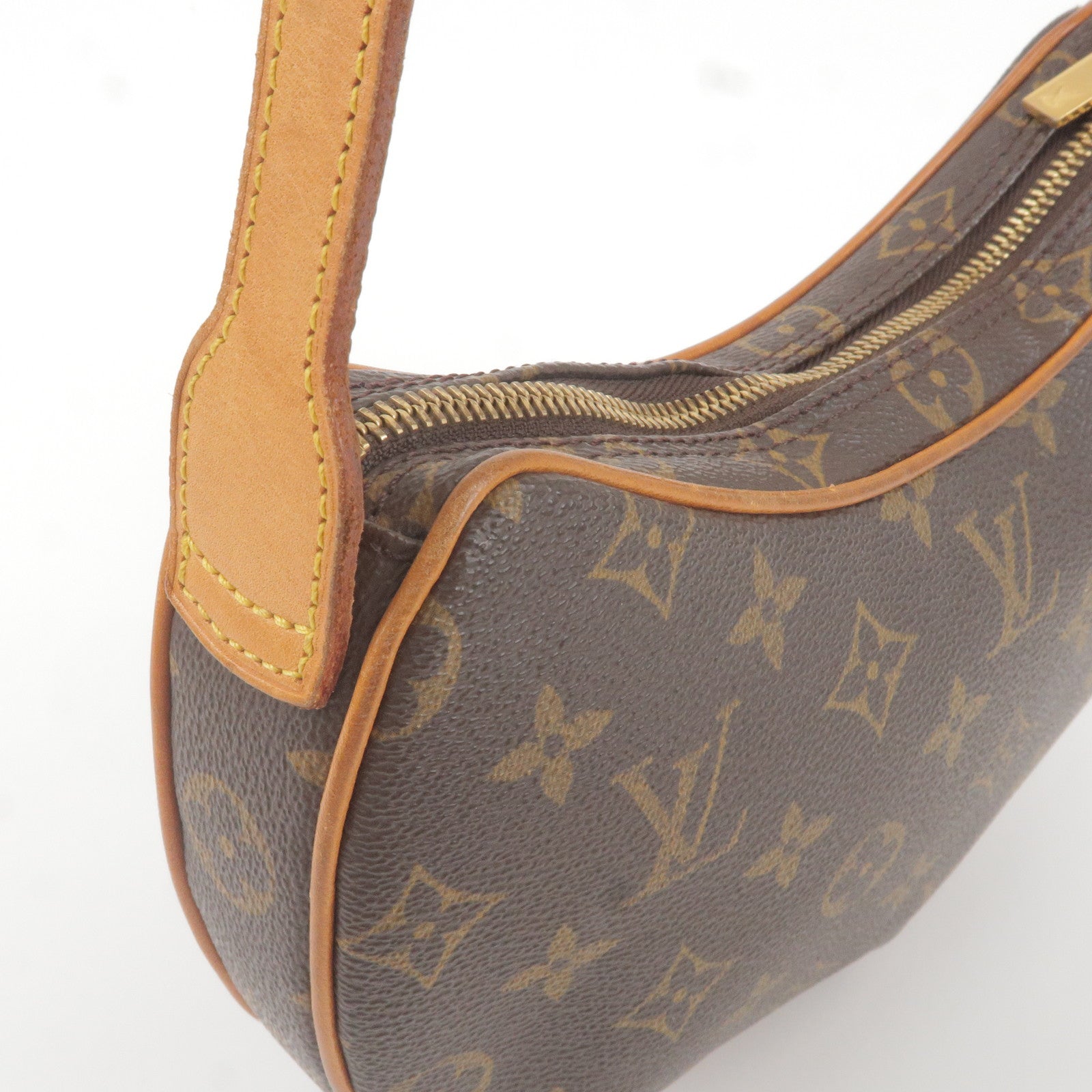 A Louis Vuitton Croissant Bag, monogrammed canvas, 10.5 length approx,  shoulder strap, suede lined. Condition; some damage to zip, wear and tear  to corners, along with the dust bad and original outer